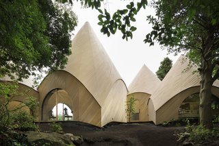 Designed for two women in their 60s, this collection of little huts is both a private home and offers a food service to the community. 