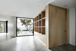 A large window at the end of the corridor on the first floor faces the river and overlooks the pool and deck. The level also includes the children's bedrooms and utilities. 