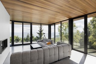 Located on the second floor, the living room hovers above the lower deck. 