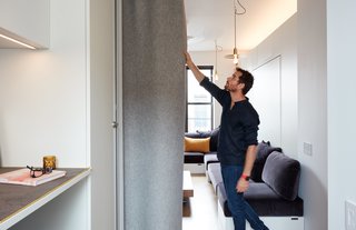 At His 350-Square-Foot Apartment, Small Space Champion Graham Hill Practices What He Preaches - Photo 1 of 15 - Graham Hill, a sustainability advocate whose TED talks have delved into the benefits of living small, put his own lessons into practice at his 350-square-foot apartment, which he shares with his partner and two dogs. Quick transitions, like drawing the FilzFelt curtain, convert the living space into a bedroom. 