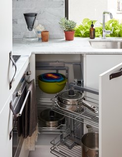 At His 350-Square-Foot Apartment, Small Space Champion Graham Hill Practices What He Preaches - Photo 9 of 15 - Clever cabinets from Resource Furniture save space for extra appliances, like a dishwasher. The counter is Bianco Carrara Lithoverde marble. 
