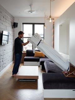 At His 350-Square-Foot Apartment, Small Space Champion Graham Hill Practices What He Preaches - Photo 12 of 15 - When the Penelope bed by Clei is tucked into the wall, the full sofa reappears; the unit includes two recessed nightstands with flip-down shelves. 