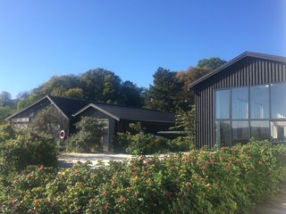 The museum director's office is located near the waterfront and is situated between several boathouses. 