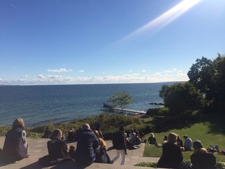 Architect Jean Nouvel was commissioned by the museum to build a dock in 2005. Visitors sit at the edge of a hill to enjoy views of the water. 