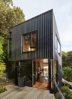 A concrete slab at the entry transitions to a staircase of recycled tawa.