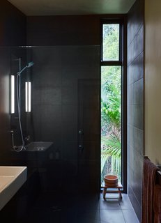 The shower is lined in Magma Black tile purchased at the Tile Space in Auckland.