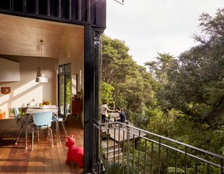 The residents wanted their house to sit within the bush, not above it. Two decks made of local purpleheart enhance the feeling of sitting among the trees, while the structure’s Dimondek 300 steel cladding provides a backdrop that makes the foliage stand out. The couple landscaped the site themselves, keeping as many native plants as possible while adding a few bromeliads, cycads, and fruit trees near the decks. 