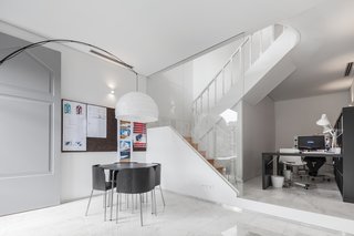 This Revived 19th-Century Home Keeps Its Character Even With a Minimalist Interior - Photo 1 of 6 - The firm used white materials throughout the renovation. The walls, ceilings, and woodwork are painted white. Portuguese Estremoz marble is featured on the ground floor. 