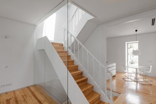 This Revived 19th-Century Home Keeps Its Character Even With a Minimalist Interior - Photo 2 of 6 - The narrow staircase captures light coming in from both the front and back sides of the home. 