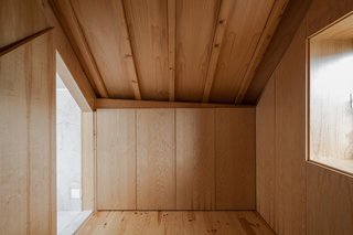 This Revived 19th-Century Home Keeps Its Character Even With a Minimalist Interior - Photo 4 of 6 - The majority of storage units are concealed by single materials. The closet on the top floor is covered in wood. 