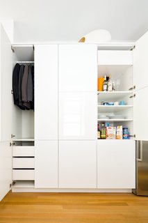 In the kitchen, a single Sektion wardrobe from IKEA is used to stow both clothing and various food and dining items. Throughout the apartment, Krajewski replaced the time-worn flooring, installing new white oak planks by Hull Forest with a buffed oil finish by Waterlox. 