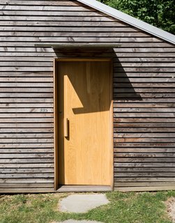 Taking a cue from a nearby farm structure, the couple used thin strips of larch to disguise imperfections in the original concrete block structure.