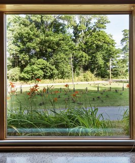Romanzia rolling blinds extend from the floor to cover the Architectural Collection glazing by Eagle Windows.