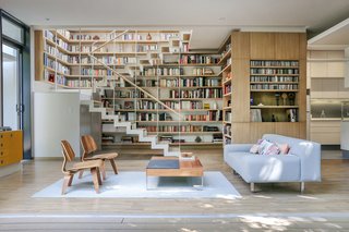 An interesting feature of the house is the library, which occupies the space surrounding the staircase. "As my parents are of a certain age, it probably would have been better to make the house just one level," architect Paul Cremoux says. But because of the land-usage law, a two-level structure was the only way to create the room his parents needed as well as accommodate his dad’s sizable collection of books. "It was obvious the stairwell would be best suited for the books because of its double height," Paul explains. "Everyone always asks how it’s possible we have only 170 meters," Nina says of reactions to the 1,775-square-foot residence. "Really, it’s just the staircase, the open kitchen space, and the height of the ceilings that add up to make it feel huge." 