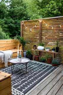Modern and minimal doesn't mean unlivable—rugs make outdoor spaces inviting. 