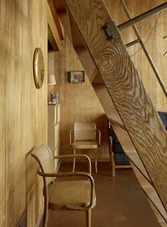 A repurposed WWII ladder is turned into a stairway that leads to the loft.
