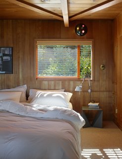Another bedroom is left simple to let the wood do the talking.