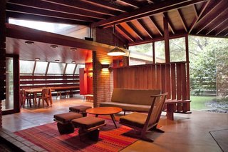 Built with redwood, glass, red brick, and concrete, the house was originally designed by John Lautner for the Schaffer family, who used to spend time enjoying picnics under the resident oak trees. Lautner built the house horizontally around the oaks.