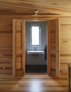 The tile-clad bathroom offers one of the home’s only breaks in material, with a wall-mounted Swing 85 ceramic sink by Artceram 