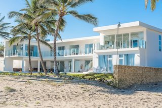 This modern beachfront home in the Dominican Republic enjoys stunning ocean views from every room. 
