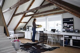The monochromatic color palette of this Portuguese home office creates a cohesive look and draws your attention to natural elements used in the architectural details of the space.