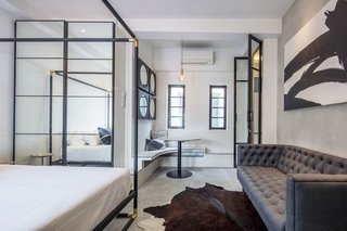 Located in a 1939 estate, this art deco-inspired, one-bedroom apartment is equipped with a queen-sized bed, workspace, sofa, and a kitchenette with a microwave and refrigerator.