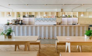 Fleet Architects used light wood to contrast with the building's concrete exterior. They custom-made the birch-plywood furniture and the wooden panels that cover the bar. 