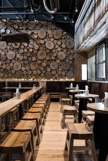 Cross sections of tree trunks line the walls of this German-style beer house in Melbourne, Australia. With various types of wood used throughout the space, the effect is multidimensional and complex, yet still warm and approachable. It's the perfect place to welcome in fall.