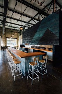 To outfit the 10,000-square-foot factory space, Hank Butitta worked with local materials and manufacturers. He framed original elements of the building with simple forms while focusing on the power of its negative spaces.