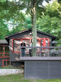 15 Brilliant Designs That Work Around Nature - Photo 6 of 15 - Built around the twin trunks of a maple tree, the Campbells’ outdoor deck provides tranquil views of the lake and a chance for the family to spot roaming wildlife while enjoying their morning coffee. During warmer months, the wide space creates an ideal secondary dining room, shaded by the canopy of leaves overhead.