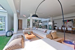 The four-bedroom Villa Momentai in Canggu (also shown in the cover photo above), can comfortably accommodate eight guests. Large sliding glass doors connect the modern interiors with a pool and lush, breezy yard. 