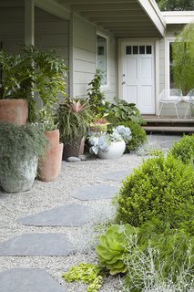 In this garden by Flora Grubb, contemporary containers and minimal furniture help to create an eclectic, modern environment. 