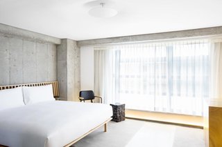 10 Modern and Stylish Places to Stay in Hong Kong - Photo 2 of 10 - Minimalism takes on a new meaning at Tuve, a boutique hotel with bare concrete walls and floors, translucent glass panels, and soft mood lighting that evokes a calm, meditative mood.