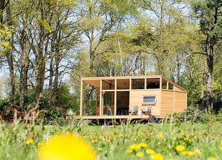 Surrounded by forest and meadows, this minimalist cabin in Lettele, Netherlands, is a prefab project by Dutch designers Arno Schuurs and Paulien van Noort. The smart and sustainable layout incorporates large windows that bring in the outdoors. Materials such as untreated Oregon pine planks, oak fishbone flooring, concrete, and raw steel were used to keep the construction footprint low. 
