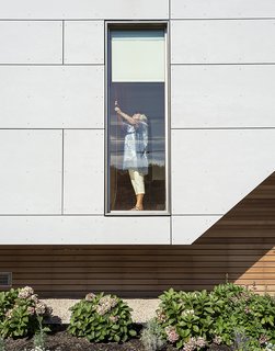 The home, which is on Long Island Sound, is made of hardworking materials. Its Gore-Tex-wrapped plywood sheathing is protected by an Equitone fiber-cement rainscreen, which is the first line of defense during harsh weather conditions. 