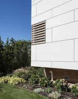 A vented skirt, also cedar, lets flooding pass under the home in a storm. "Western red cedar has been used near the water in the Northeast for centuries," Berg notes. The site <br>falls in an AE Zone, one of FEMA’s riskiest Special Flood Hazard Areas, so the first floor had to be raised <br>two feet above Base Flood Elevation, or 14 feet above sea level. 