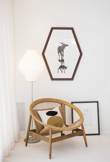Back to the Garden - Photo 3 of 13 - The furnishings are a mix of inherited midcentury pieces and eBay finds, including the circular Danish chair with a woven seat in the living area. The All White paint seen throughout the house is by Farrow & Ball. 