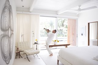 Back to the Garden - Photo 4 of 13 - Custom curtains by Katie Koch Home offer privacy in the master suite, where Ron plays the trumpet. The couple own a mix of new and vintage Mies van der Rohe Barcelona chairs. 