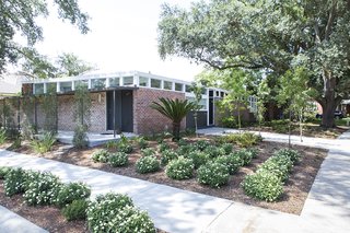 Back to the Garden - Photo 10 of 13 - Plantings: Evans + Lighter Landscape Architecture, contractor Sandra Tomasetti, and architecture firm studioWTA collaborated to develop a roofline without gutters above the walkway and carport. Instead, water is channeled to feed the garden. The result is a California-inspired yard with geometrically laid-out plantings rather than grass. "It’s rows of green with mulch permeating," Maury says. 