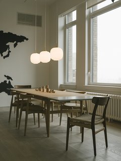 Warp Speed - Photo 6 of 12 - The finished chairs are made to the exact specifications of Wegner’s 1949 design. The only difference is that the original was manufactured in teak, while the new versions are available in more sustainable oak or American walnut. Here, they appear at the head of a Wegner CH327 dining table. 