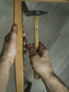 Warp Speed - Photo 7 of 12 - 1. Hammer Once Small L-shaped nails are hammered into the front and back seat rails. 