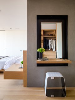 Like the bed and built-in nightstand, the door is by Lloyd’s Custom Woodwork. The WGS stool near the vanity is by Gallotti&Radice. 