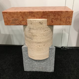 A Tuscan Stool made in Italy by Oevffice for Matter, handcrafted from three different stones: Rosso Verona Marble, Roman Travertine, and Luzerna stone. 
