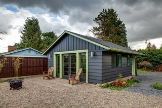This simple ADU sits in the corner of a backyard. The exterior paint colors reflect the palette of the main home and creates uniformity.