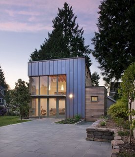 This Seattle ADU makes a modern statement that's clad in copper and cedar. The backyard "garden pavilion" connects to the main house by way of an expansive slate courtyard. 