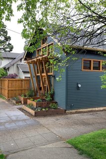 A wood trellis offers coverage and marks the entry to this 700-square-foot cottage ADU.