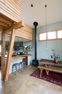 The tall space over the main room features timber detailing and ample natural light from high windows—which also offer privacy from the main house. 