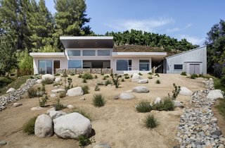 The architecture firm tackled the hardscape: patios, pathways, and gabion walls. Landscape designer Marilyn Guidroz worked with existing native plants on the site and added more species to ensure there would be blooms year-round for the bees kept by resident Ron Krohn. 