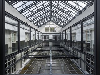 Formerly a Historic Bank, This Amsterdam Hotel Honors its Stately Roots - Photo 5 of 14 - A glass bridge traverses the atrium.
