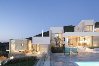10 Modernist Beach Home Rentals to Escape to This Summer - Photo 1 of 10 - Designed by architect Nikitas Hatzimichalis, these villas are designed to work in harmony with the complex topography of a lush Greek island on the Aegean Sea. It effectively highlights views of the Skiathos beaches and coast of Pelion. Each villa has its own swimming pool that overlooks the sea, and is ensconced by green verandas for added privacy. 